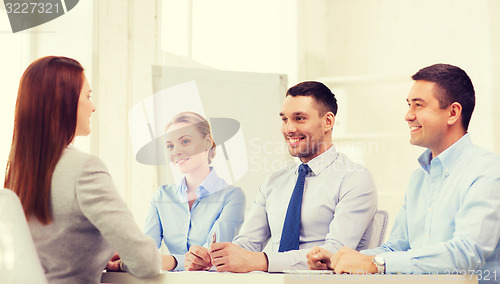 Image of smiling businesswoman at interview in office