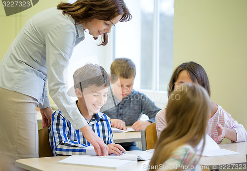 Image of group of school kids writing test in classroom