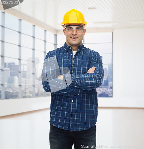 Image of smiling male builder or manual worker in helmet