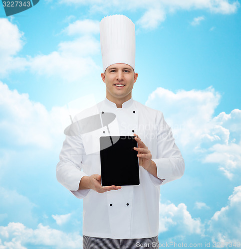 Image of happy male chef cook showing tablet pc