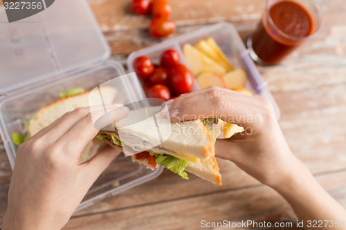 Image of close up of woman with food in plastic container