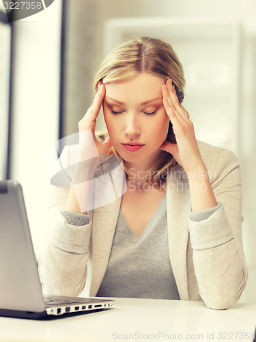 Image of tired woman with laptop computer