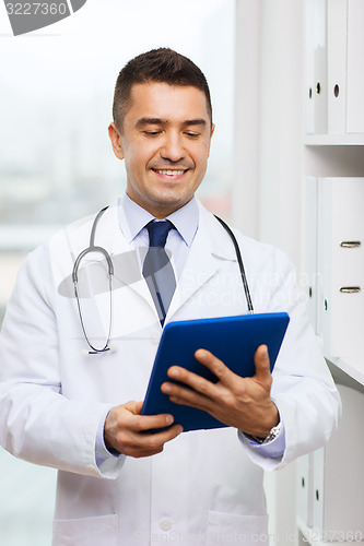 Image of smiling male doctor in white coat with tablet pc