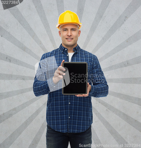 Image of smiling male builder in helmet with tablet pc