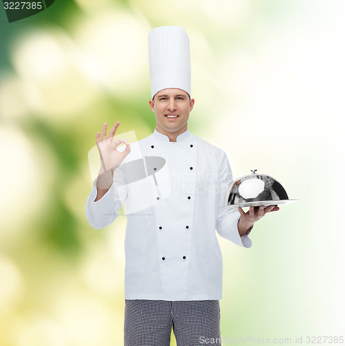 Image of happy male chef cook with cloche showing ok sign