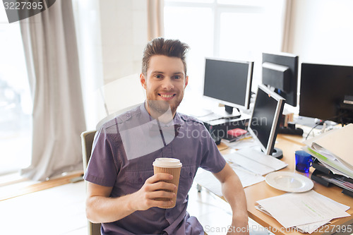 Image of happy creative male office worker drinking coffee