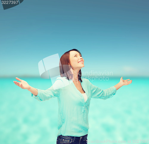 Image of smiling woman waving hands