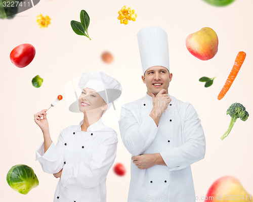 Image of happy chef couple or cooks over food background