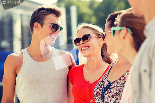 Image of group of smiling friends in city