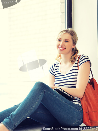 Image of happy and smiling teenage girl with laptop