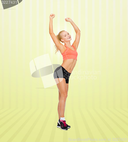 Image of happy beautiful sporty woman dancing