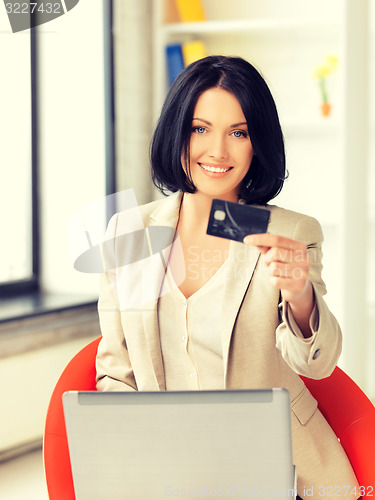 Image of happy woman with laptop computer and credit card