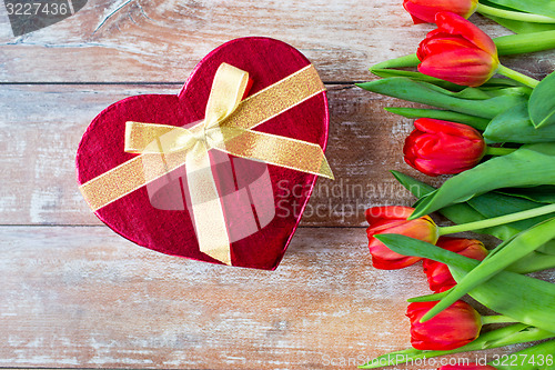 Image of close up of red tulips and chocolate box