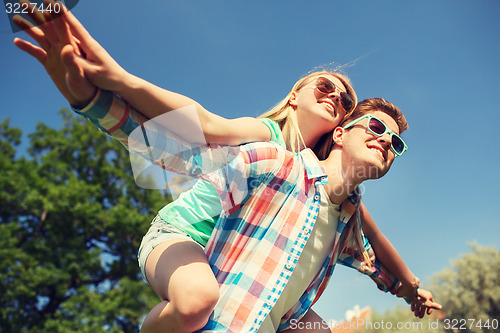 Image of smiling couple having fun in park