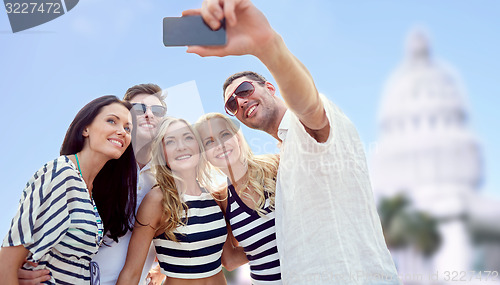 Image of friends taking selfie with smartphone