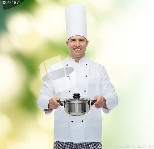 Image of happy male chef cook holding pot