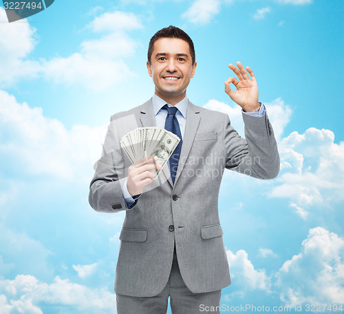 Image of smiling businessman with american dollar money