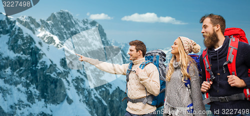 Image of group of smiling friends with backpacks hiking