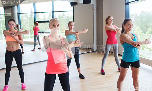 Image of group of happy women working out in gym