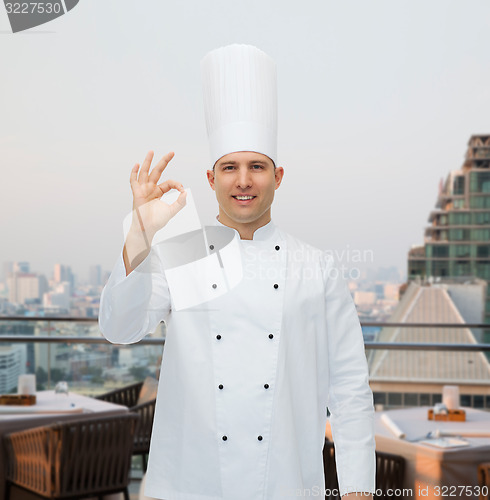 Image of happy male chef cook showing ok sign