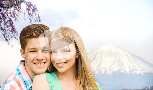 Image of smiling couple hugging over fuji mountain in japan