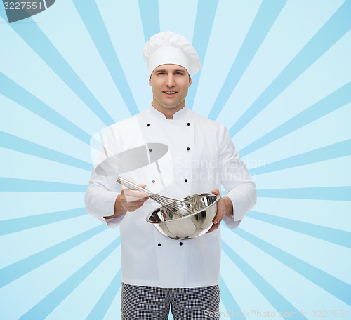 Image of happy male chef cook whipping something with whisk