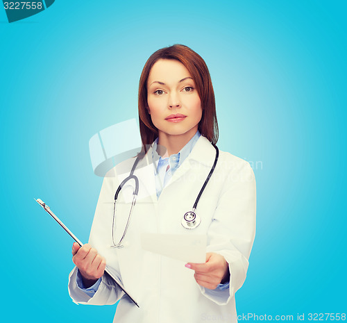 Image of calm female doctor with clipboard