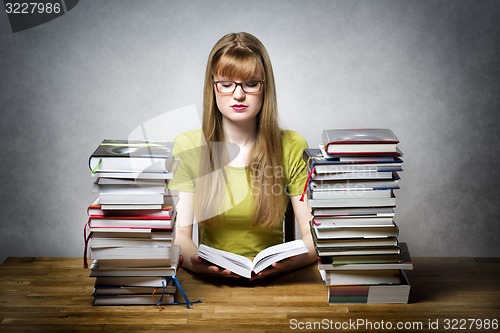 Image of young woman is reading book