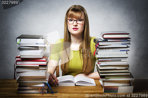 Image of young woman is reading book