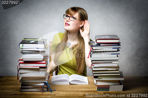 Image of Listening female student with books