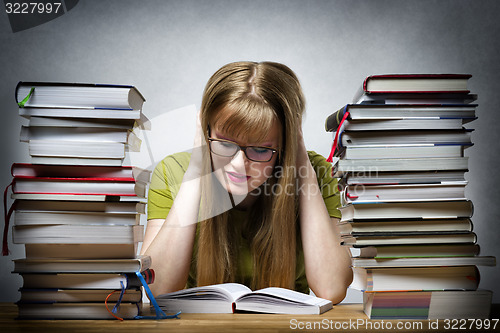 Image of young woman is reading book