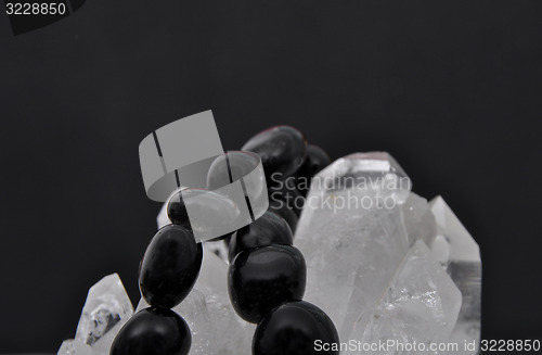 Image of Obsidian on rock crystal