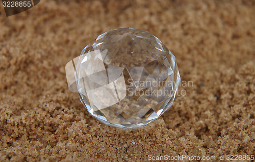 Image of Crystal ball on sand