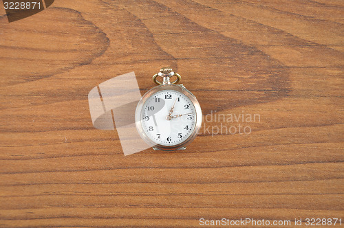 Image of Pocket watch on wood