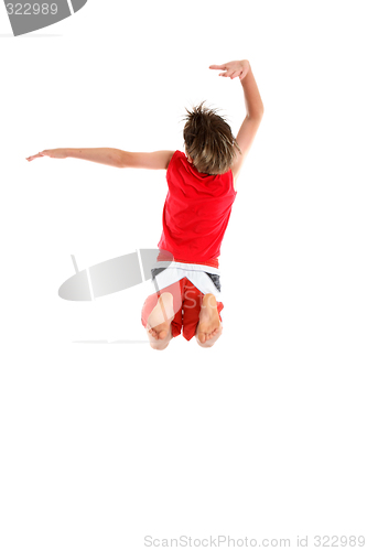 Image of Boy jumping arms in grande pose.