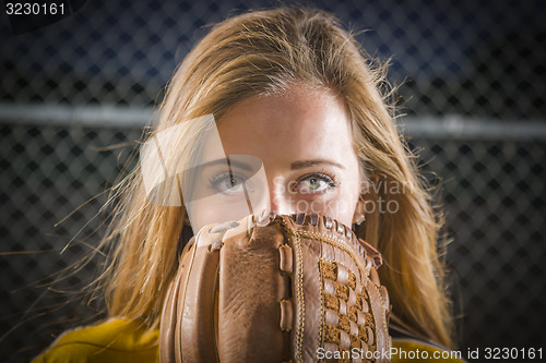 Image of Young Woman with Softball Glove Covering Her Face Outdoors