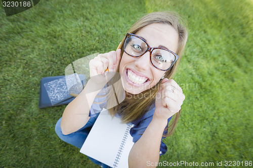 Image of Wide Angle of Pretty Young Woman with Books and Pencil