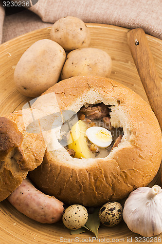 Image of traditional white borscht (zurek) with sausage,egg and mushrooms