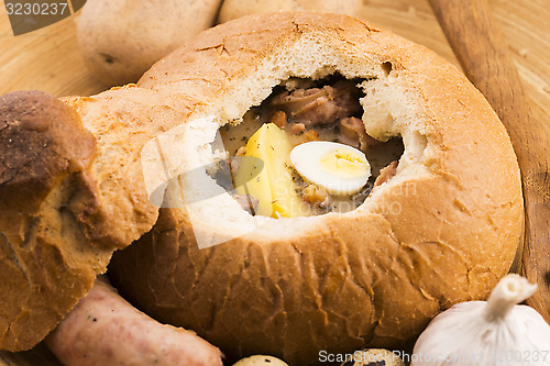 Image of traditional white borscht (zurek) with sausage,egg and mushrooms