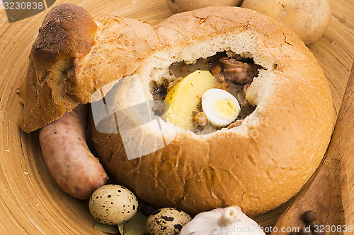 Image of traditional white borscht (zurek) with sausage,egg and mushrooms