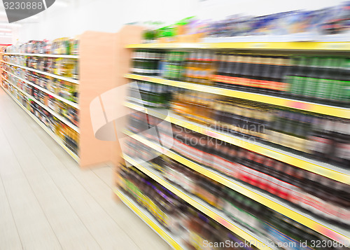 Image of Shelves with beverages bottles in grocery food store in supermar