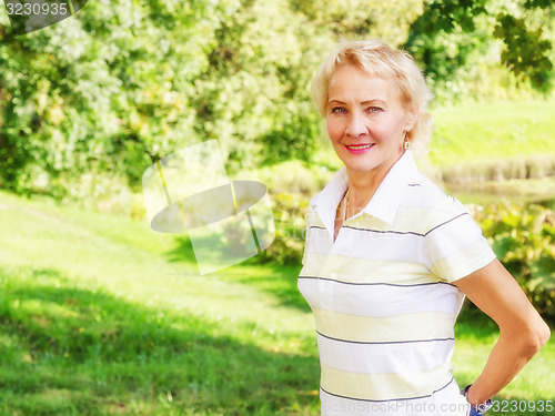 Image of Portrait of a middle-aged woman in a park  