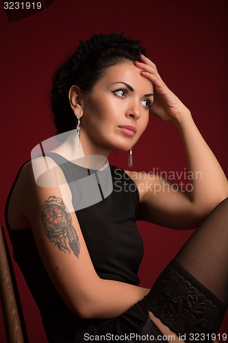 Image of Studio portrait of a sexy brunette in black stockings