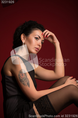 Image of Studio portrait of a sexy brunette in black stockings