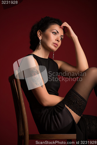 Image of Studio portrait of a sexy brunette in black stockings