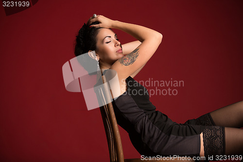 Image of Studio portrait of a sexy brunette in black stockings