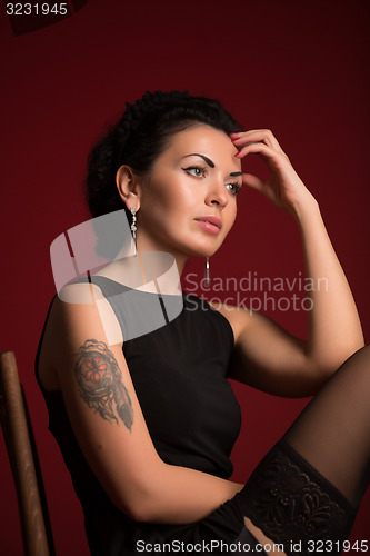 Image of Studio portrait of a sexy brunette in black stockings