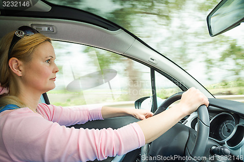Image of Profile portrait of serious calm woman carefullly safe driving c