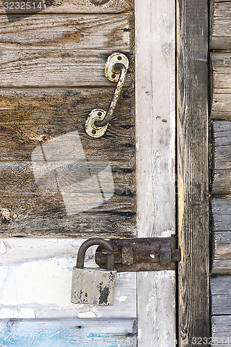 Image of Wooden door locked with padlock