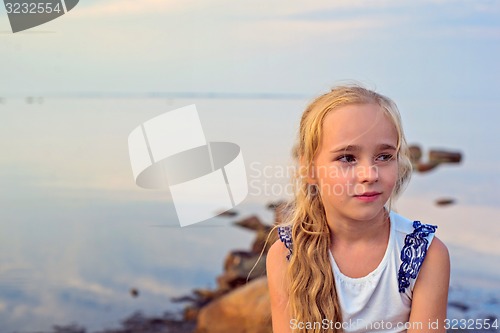 Image of Portrait of little beautiful girl on sunset